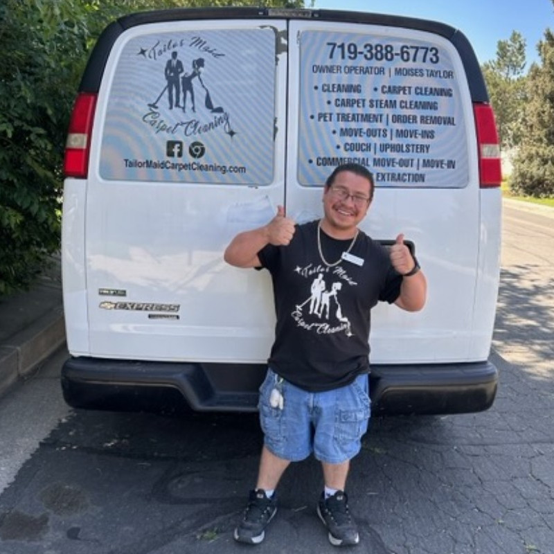 Moises Taylor Owner of Tailor Maid Carpet Cleaning in front of his van