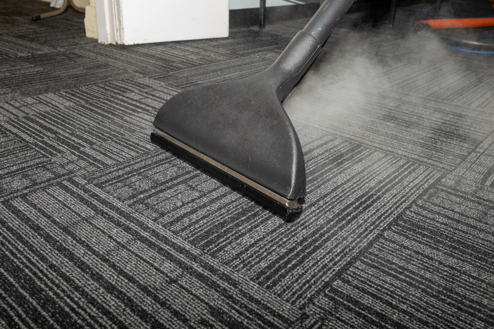 A steam cleaner is used to clean the carpet of an office floor